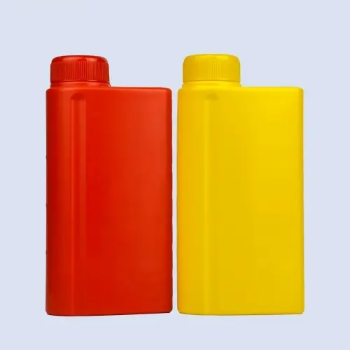 Red and yellow flat HDPE engine oil bottles with screw caps front view